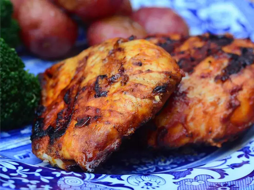 Good Frickin Paprika Chicken pieces on a baking sheet, seasoned with a blend of paprika and spices recipe