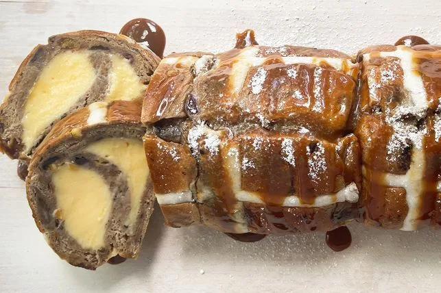 "Hot Cross Bun Custard Roll: A unique dessert with layers of spiced buns and creamy custard"